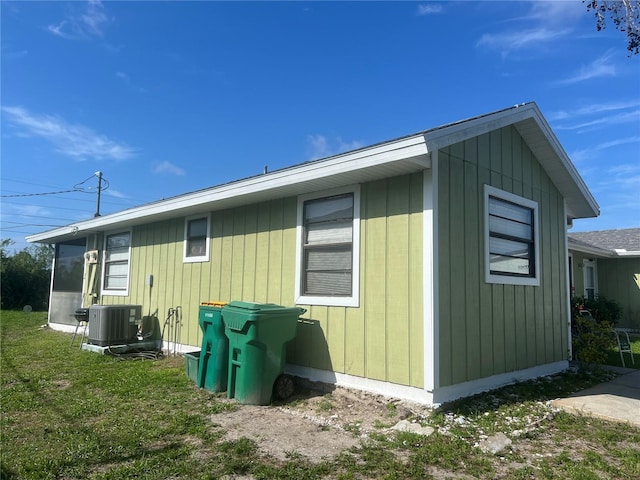 view of side of home with central AC unit