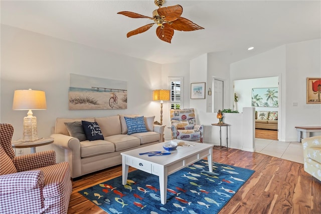 tiled living room featuring vaulted ceiling and ceiling fan