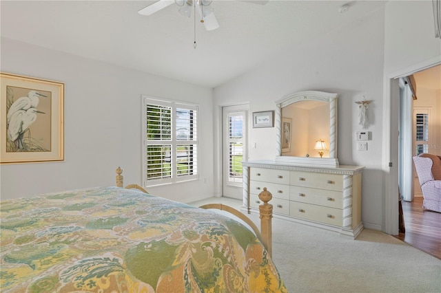 carpeted bedroom featuring lofted ceiling and ceiling fan