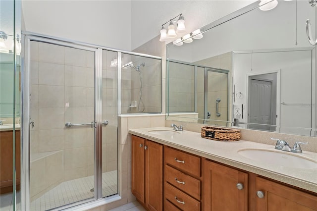 bathroom featuring oversized vanity, dual sinks, and walk in shower