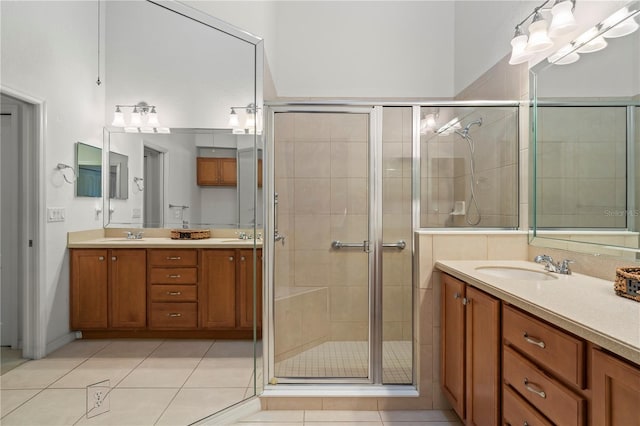 bathroom with tile flooring, an enclosed shower, and dual bowl vanity