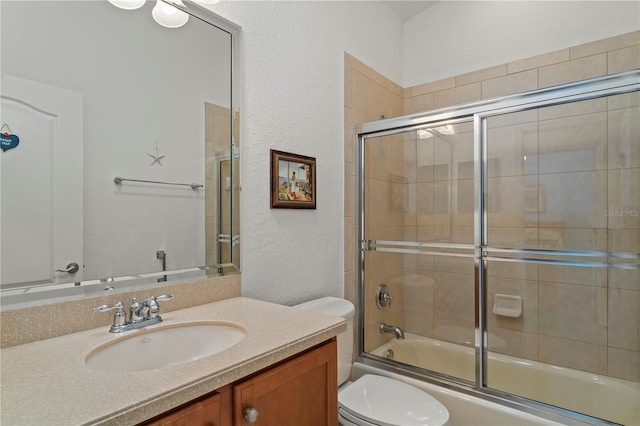 full bathroom featuring bath / shower combo with glass door, toilet, and vanity