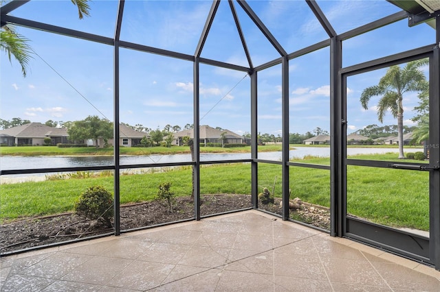 unfurnished sunroom with a water view