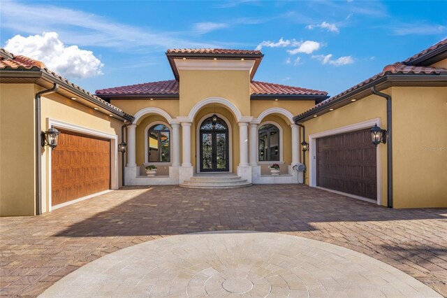 mediterranean / spanish house featuring french doors and a garage