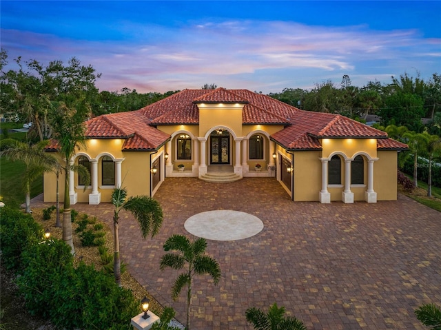 mediterranean / spanish home with a patio area