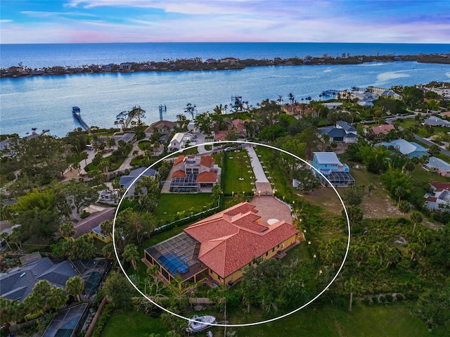 aerial view at dusk with a water view