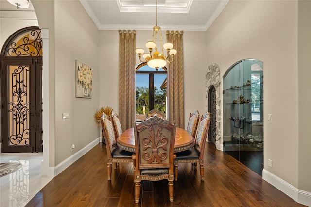 dining space with french doors, dark hardwood / wood-style floors, a notable chandelier, and ornamental molding