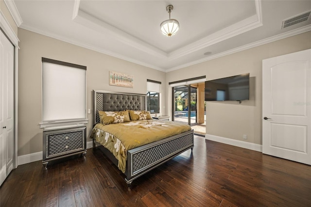 bedroom with access to exterior, dark hardwood / wood-style flooring, ornamental molding, a raised ceiling, and a closet