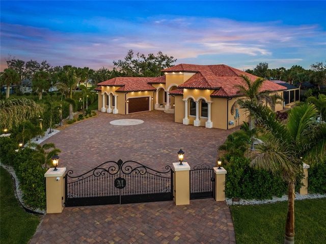 mediterranean / spanish home with a garage