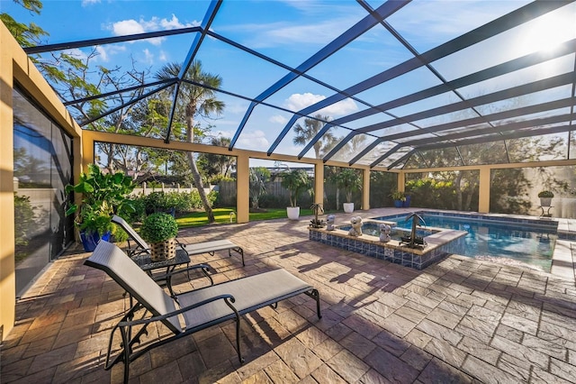 view of pool featuring a lanai, a patio area, and an in ground hot tub