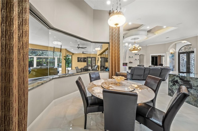 dining space with crown molding and ceiling fan with notable chandelier