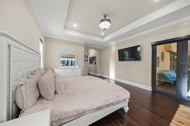 bedroom featuring access to outside, a tray ceiling, ornamental molding, and dark wood-type flooring