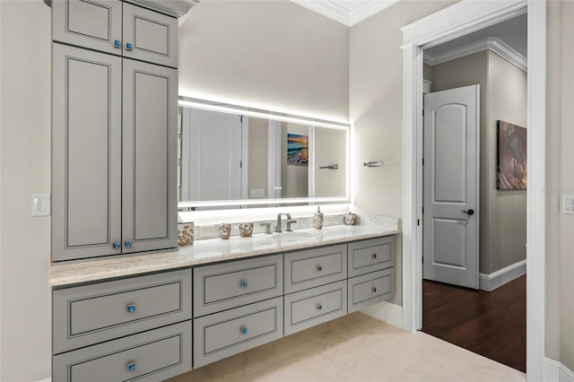 bathroom featuring tile patterned flooring, vanity, and crown molding