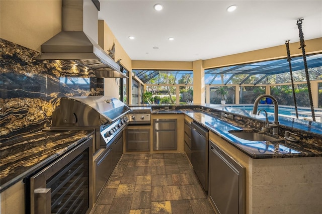 view of patio featuring sink, beverage cooler, an outdoor kitchen, a lanai, and area for grilling