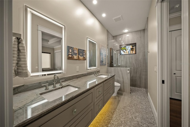 bathroom with crown molding, vanity, and toilet