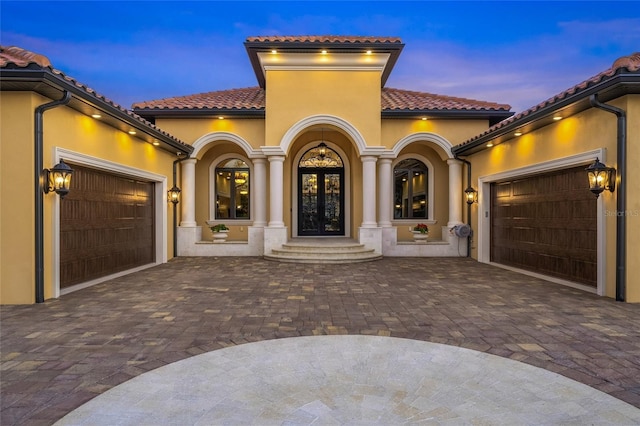 view of front facade with french doors and a garage