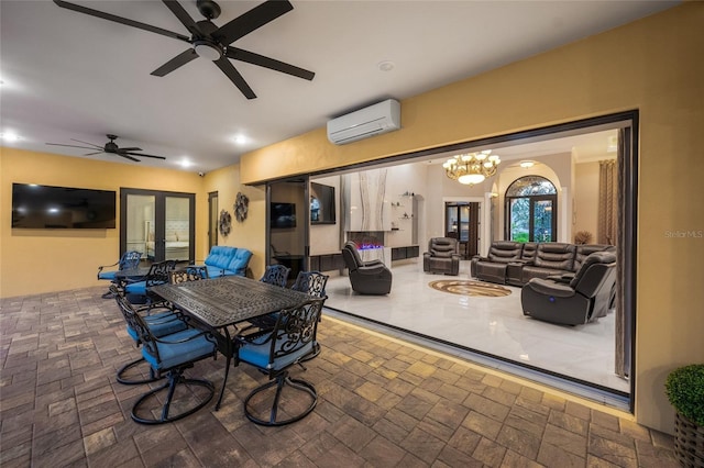 view of patio / terrace featuring an outdoor hangout area, a wall unit AC, and french doors