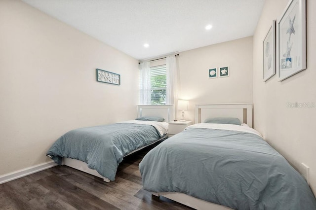 bedroom with dark hardwood / wood-style floors