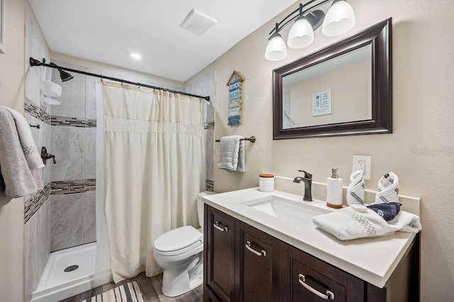 bathroom with a shower with curtain, hardwood / wood-style floors, toilet, and vanity