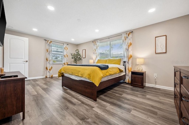 bedroom featuring dark hardwood / wood-style floors and multiple windows