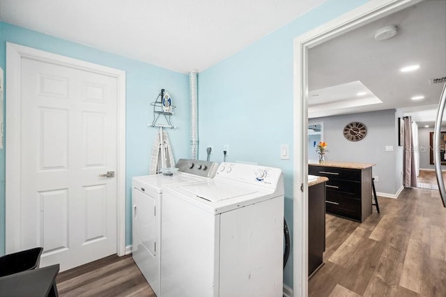 washroom with separate washer and dryer and hardwood / wood-style flooring