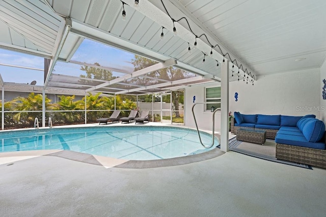 view of pool with a patio, glass enclosure, and outdoor lounge area