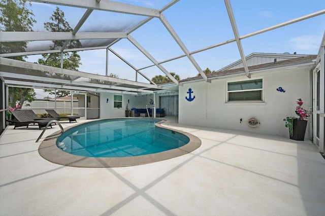 view of swimming pool featuring a patio area and a lanai