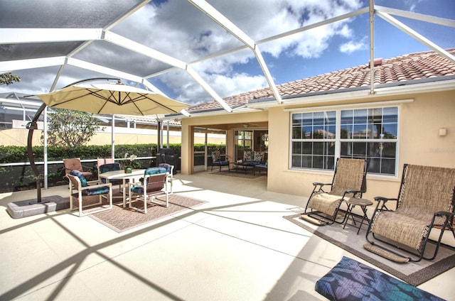 view of patio featuring glass enclosure