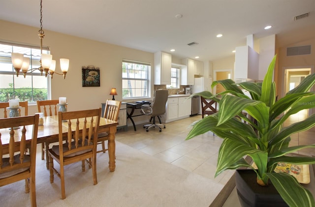 dining space featuring light tile patterned floors and an inviting chandelier