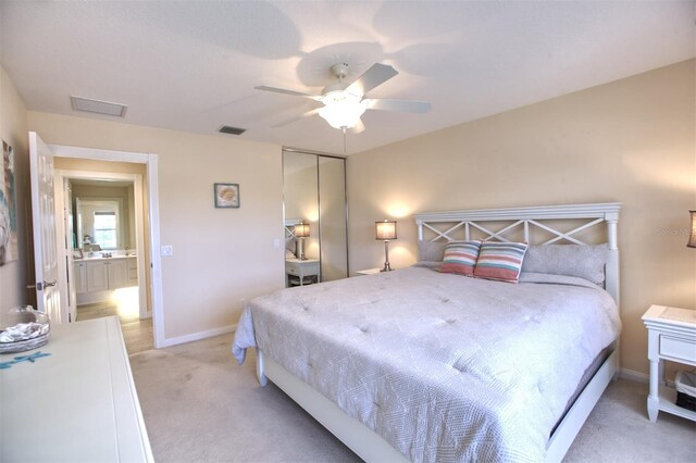 bedroom featuring light carpet, a closet, and ceiling fan