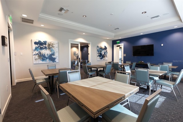 dining area with crown molding and a tray ceiling