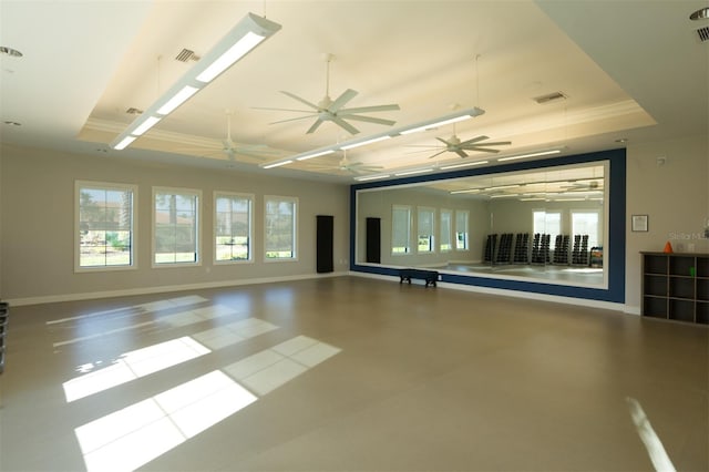 empty room featuring plenty of natural light and a tray ceiling