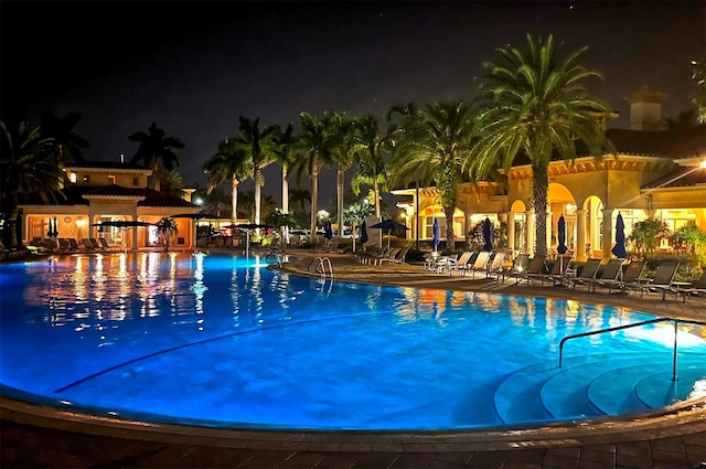 pool at twilight featuring a patio