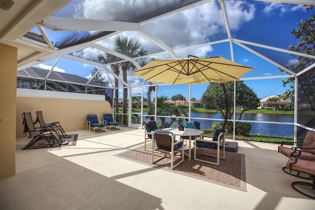 view of patio with a water view and a lanai