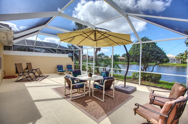 view of patio featuring glass enclosure and a water view