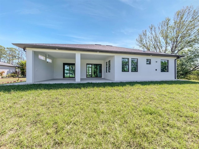 back of house with a lawn and a patio area