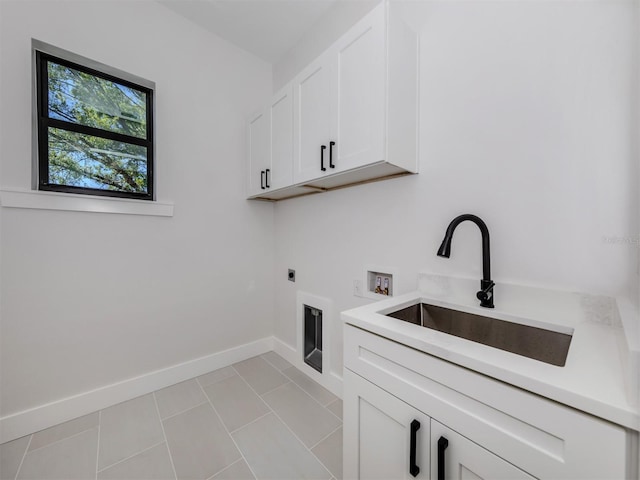 washroom featuring electric dryer hookup, light tile floors, cabinets, hookup for a washing machine, and sink