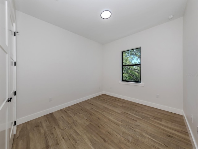 spare room with dark wood-type flooring