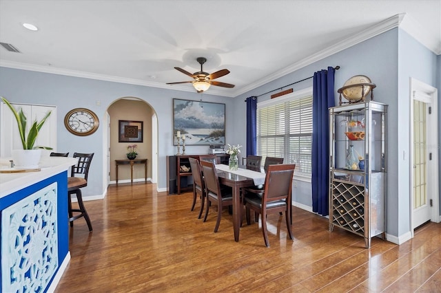 dining room with ornamental molding, ceiling fan, and wood-type flooring