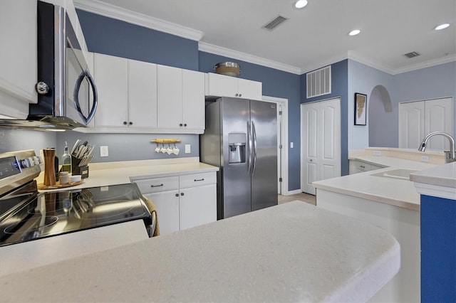 kitchen with ornamental molding, white cabinetry, sink, and stainless steel appliances