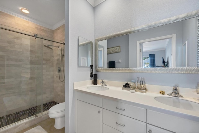 bathroom with an enclosed shower, double sink vanity, crown molding, and toilet