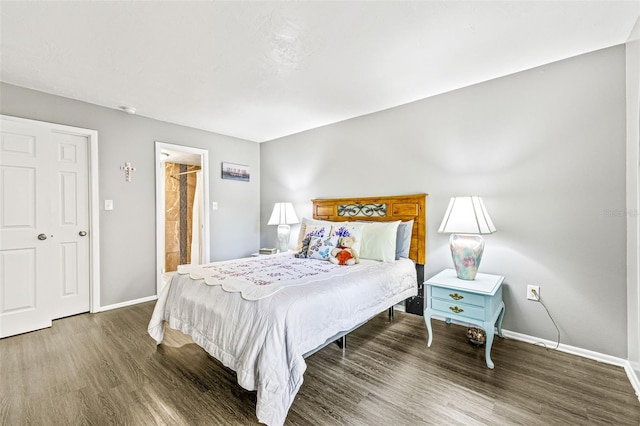 bedroom with dark hardwood / wood-style flooring and ensuite bathroom