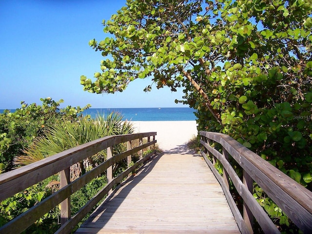 surrounding community featuring a water view and a view of the beach