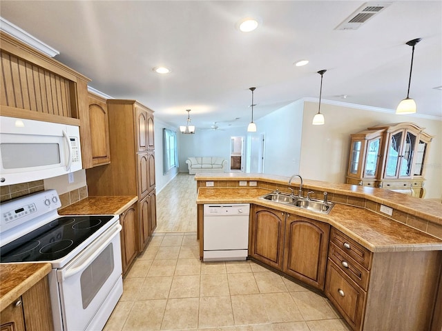 kitchen featuring crown molding, white appliances, sink, and hanging light fixtures