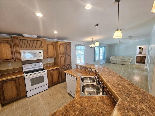 kitchen featuring sink, hanging light fixtures, white appliances, light tile patterned floors, and ornamental molding