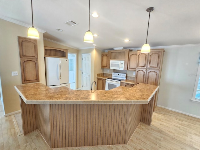 kitchen featuring decorative light fixtures, a spacious island, white appliances, and ornamental molding