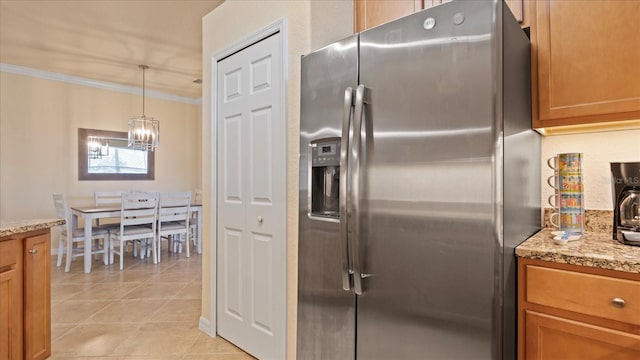 kitchen with decorative light fixtures, crown molding, an inviting chandelier, light stone counters, and stainless steel fridge