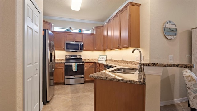 kitchen featuring dark stone countertops, stainless steel appliances, sink, and light tile flooring