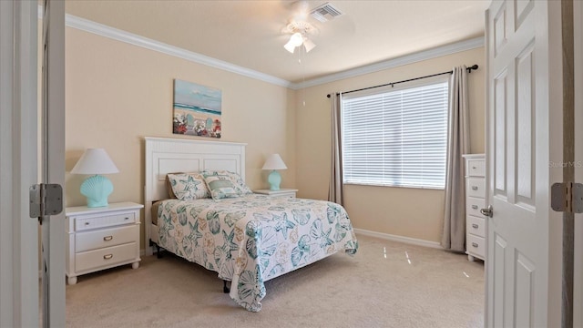 carpeted bedroom featuring crown molding and ceiling fan