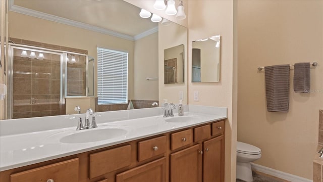 bathroom featuring crown molding, toilet, and double sink vanity